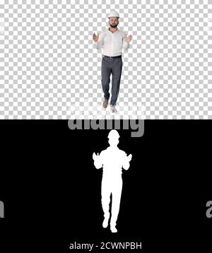 Engineer in hardhat walking and explaining something, Alpha Chan Stock Photo