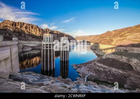 Reflection of the Hoover Dam and surrounding mountains on the surface of Lake Mead on the Arizona and Nevada border. Stock Photo