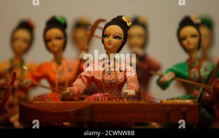 A collection entitled 'The Thai Musical Doll' is displayed during the World Costume Dolls exhibition at the National Textile Museum in Kuala Lumpur July 12, 2013. The museum exhibits a collection of dolls in traditional costumes worn by local residents and ethnic groups from around the world. REUTERS/Bazuki Muhammad (MALAYSIA - Tags: SOCIETY)