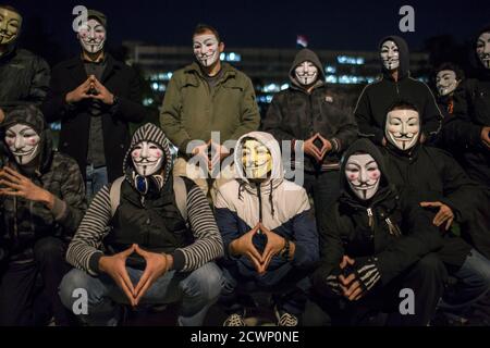Protesters wearing Guy Fawkes masks pose for a picture in a park in downtown Belgrade November 5, 2014, on the day marking Guy Fawkes Night. REUTERS/Marko Djurica (SERBIA - Tags: SOCIETY ANNIVERSARY CIVIL UNREST POLITICS)