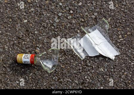 Broken glass from a broken wine bottle on the ground Stock Photo