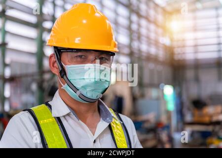 Asian male engineer wearing protective mask to Protect Against Covid-19 in  the factory,Coronavirus has turned into a global emergency,Coronavirus Dise  Stock Photo - Alamy