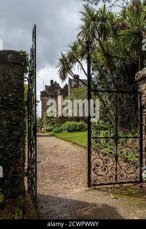 Ornate gates leading to Brodick Castle. The castle stands in an elevated position at the foot of Goatfell mountain on the island of Arran, Scotland. Stock Photo