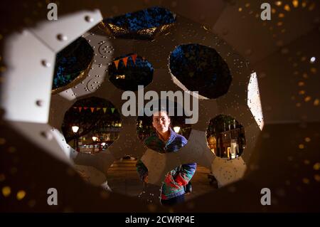 EDITORIAL USE ONLY Members of the public look at an art installation called 'In Bloom', installed as part of a public art trail for Kensington & Chelsea Art Week, as it is unveiled at Sloane Square, London. Stock Photo