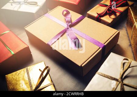 gift wrapping service - wrapped present boxes on dark table Stock Photo