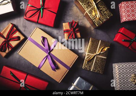 variety of wrapped gift boxes on black stone background. top view Stock Photo