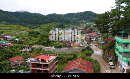 Aerial view town of Sagada, located in the mountainous province of Philippines. City in the valley among the mountains covered with forest. Sagada-Cordillera region-Luzon island. Stock Photo