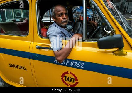 Kolkata, India - September 2020: A taxi driver waiting inside his taxi on a street in Kolkata on September 27, 2020 in West Bengala, India. Stock Photo