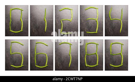 Collection of the numbers zero to nine in digital digits laid out by green beans on dark table surface Stock Photo