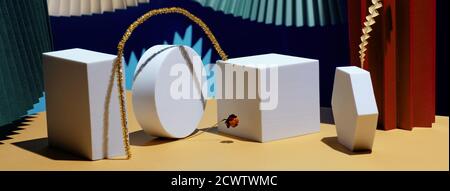 Composition of geometric shapes and colored fans made of cardboard. Concept. Banner Stock Photo