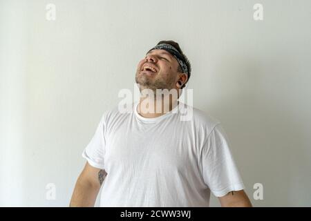 Cool guy with a black bandana on his head isolated on a white background Stock Photo