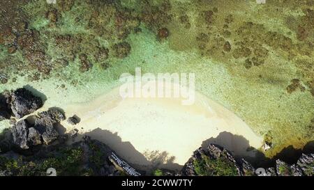 Travel concept: Sandy beach and turquoise water. Tourists on a tropical beach, aerial view. Marcos Island, Hundred Islands National Park, Pangasinan, Philippines. Alaminos. Summer and travel vacation concept Stock Photo