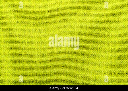 Green natural linen fabric textile material texture as a background. Green textile pattern for design in fashion as abstract background. Abstract Stock Photo