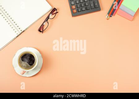 stylish table desk, workspace. Workplace in office with modern desk. Top view from above of calculator with notepad and coffee. Flat lay with blank co Stock Photo