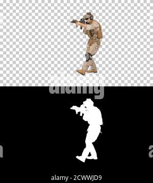 Walking ranger aiming with assault rifle, Alpha Channel with Sil Stock Photo