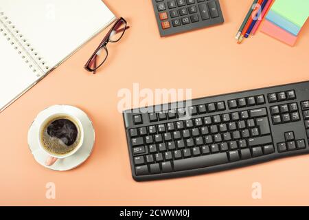 Top view from above of keyboard with notepad and coffee. Flat lay with blank copy space. Finance or business background Stock Photo