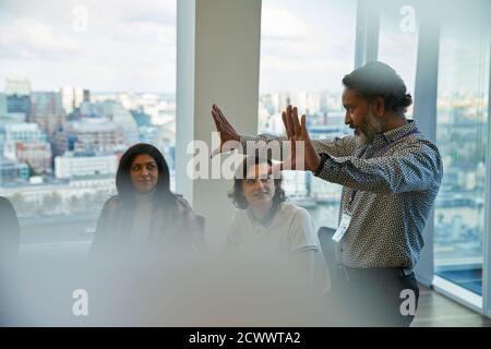 Businessman leading conference room meeting Stock Photo
