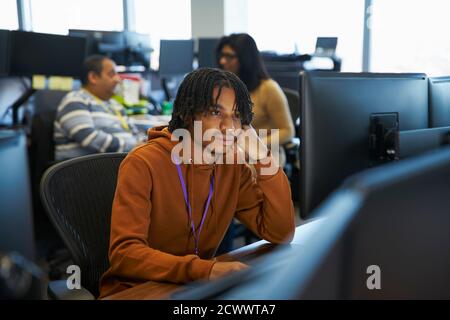Businessman working at computer in office Stock Photo