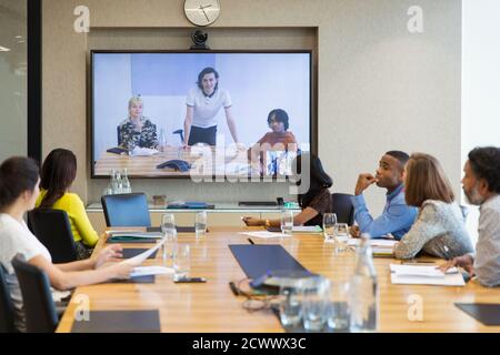 Business people video conferencing in conference room Stock Photo