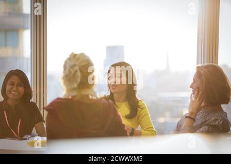 Businesswomen talking in conference room meeting Stock Photo