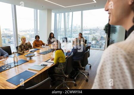 Business people in highrise conference room meeting Stock Photo