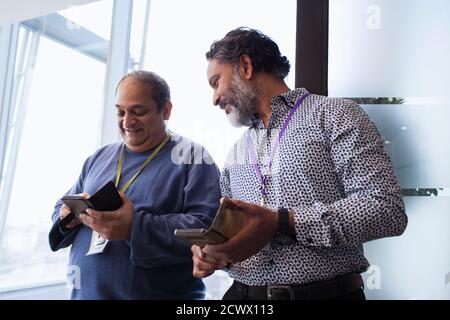 Businessmen using smart phones in office Stock Photo