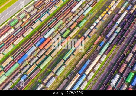Cargo railway carriage. Colorful freight trains on the railway sort facility. Wagons with goods on railroad. Heavy industry, industrial scene Stock Photo