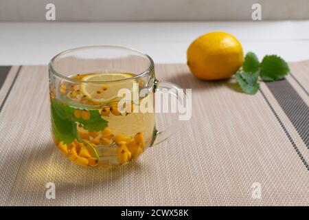 A cup of tea with and Ingredients on a brown background. Warming autumn beverage. Selective focus. Horizontal orientation. Stock Photo