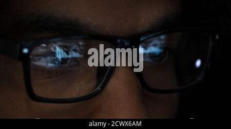 Close up reflection of laptop in eyeglasses of businesswoman Stock Photo