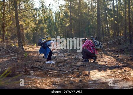 Young hiking couple using camera in woods Stock Photo