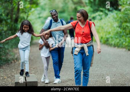 Happy family walking on park trail Stock Photo