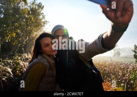 Happy young couple taking selfie on hike Stock Photo