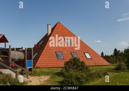 House build as pyramid. Tiled roof. Oriental approach used in Europe. Stock Photo
