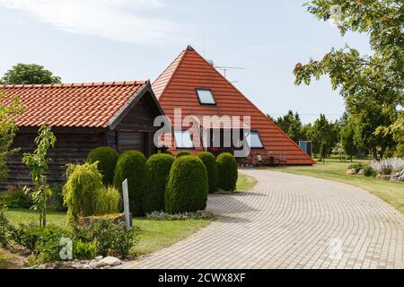 House build as pyramid. Tiled roof. Oriental approach used in Europe. Stock Photo