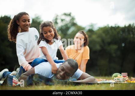 Happy family enjoying picnic in park Stock Photo