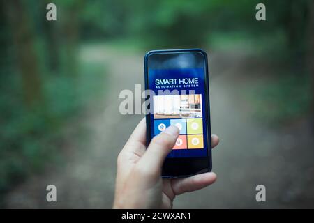 Close up POV home automation app on smart phone screen Stock Photo
