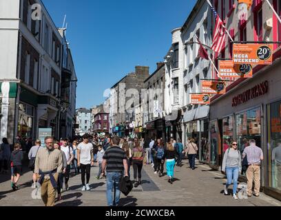 GALWAY CITY, IRELAND - 5th May, 2018: People walking on busy pedestrian Downtown area of Shop street in Galway city Stock Photo