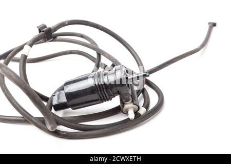 Black plastic glass washer pump reservoir with wire and hose on a white isolated background. Used spare parts from junkyard catalog. Stock Photo