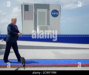 President Donald Trump walks out of the Trump International Hotel on ...