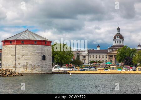 Shoal tower, Kingston, Ontario, August 2014 - Boats and limestone fortification on the waterfront with city hall in the background Stock Photo