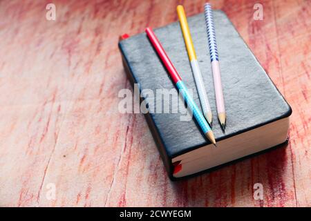 close up of a diary and pencils on table  Stock Photo