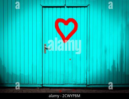 Painted Red Heart on a Turquoise Wooden Door Stock Photo