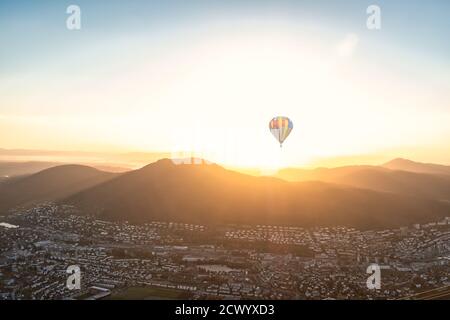 Cityscape of Bergen, Norway with mountains and hot air balloon in sunshine. Panoramic aerial view. Stock Photo