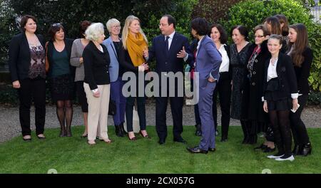 French President Francois Hollande and Minister of Women's Rights and Spokesperson of the Government Najat Vallaud-Belkacem (8th L) speak with women from four generations after a meeting in Paris, March 8, 2014. On March 8, activists around the globe celebrate International Women's Day, which dates back to the beginning of the 20th Century and has been observed by the United Nations since 1975. The UN writes that it is an occasion to commemorate achievements in women's rights and to call for further change. REUTERS/Philippe Wojazer (FRANCE - Tags: EDUCATION POLITICS ANNIVERSARY)