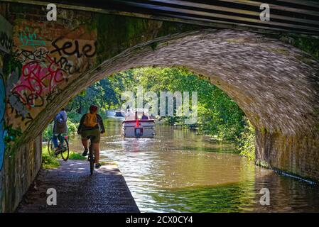 Private leisure boats passing along the River Wey Navigation  and canal at New Haw on a sunny summers day, Surrey England UK Stock Photo