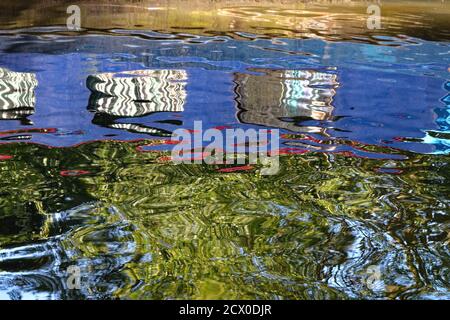 Abstract patterns made by the reflections in water of a narrow boat Stock Photo