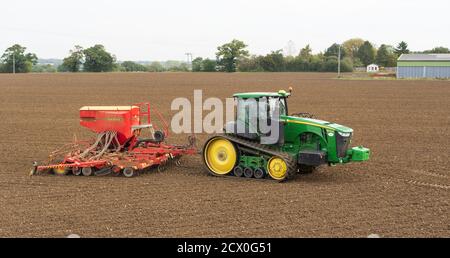 Tractor sowing seeds in a field in the Autumn. Much Hadham, Hertfordshire. UK Stock Photo