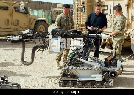 Britain's Prime Minister David Cameron is shown a remote-controlled improvised explosive device (IED) detection unit, during his visit to Camp Bastion in Helmand province, Afghanistan June 29, 2013. Cameron flew into Afghanistan on Saturday to try to reinvigorate stalled peace talks with the Taliban and reassure Afghans that foreign troops will not cut and run next year.  REUTERS/Leon Neal/pool    (AFGHANISTAN - Tags: POLITICS MILITARY)