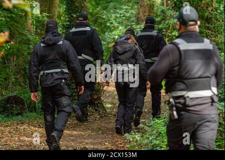 Denham, UK. 30th September, 2020. The somewhat intimidating sight of HS2 Security teams on a public path en route to join other security staff who were blocking access to a public area of Denham Country Park this morning whilst HS2 were tree felling in an area that they allegedly don't have permission for. They blocked access to both members of the public and press today on the grounds of health and safety. Many local residents oppose HS2 as do environmental campaigners and activists. Credit: Maureen McLean/Alamy Live News Stock Photo
