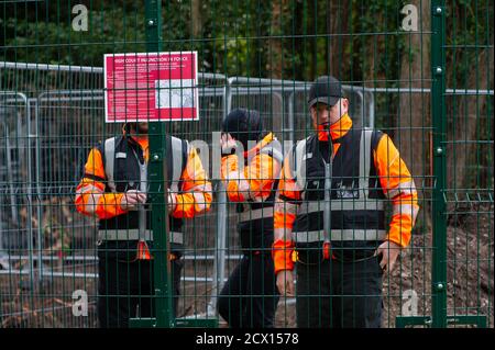 Denham, UK. 30th September, 2020. HS2 personnel guard an area of land that they have requisitioned from the public Denham Country Park next to the chalk stream River Colne as they prepare to build an access bridge across the river. The HS2 High Speed Rail link which is vastly over budget,  is causing huge destruction to woodlands along the route from London to Birmingham. Many local residents oppose HS2 as do environmental campaigners and activists. Credit: Maureen McLean/Alamy Live News Stock Photo
